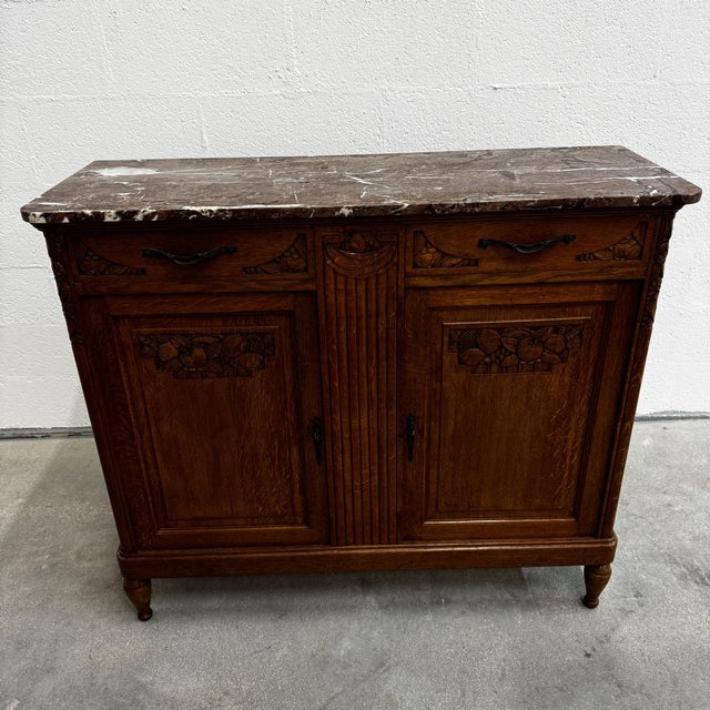 This Art Deco sideboard, dating from the early 1920s or 1930s, is a piece of refined cabinetmaking that exemplifies the...
