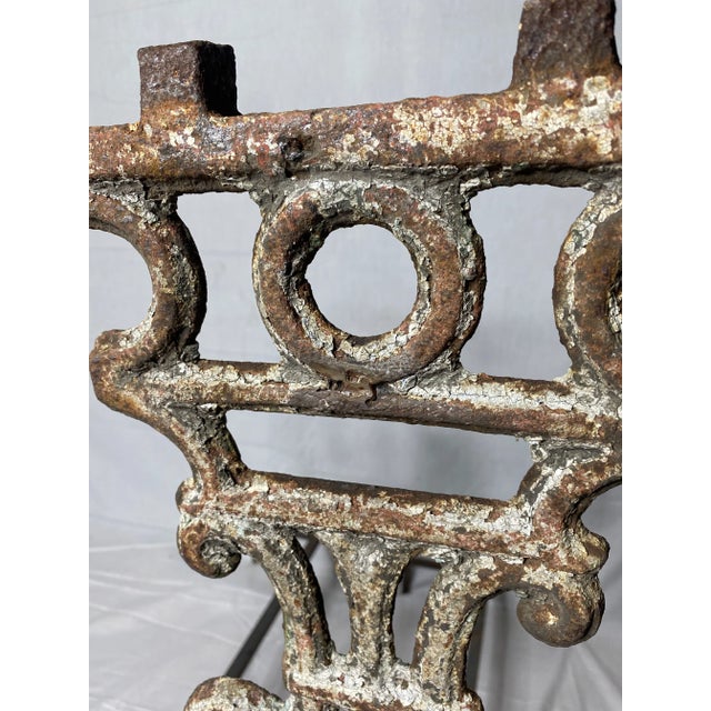 Striking one of a kind custom andirons fabricated out of a pair of incredibly patinated antique wrought iron balcony posts.