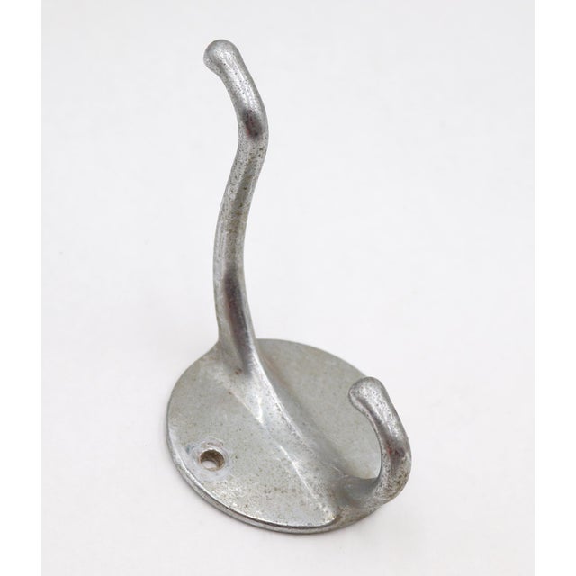 Vintage wall hook with two arms made of brushed aluminum. The original mounting screws are not available. Good condition...