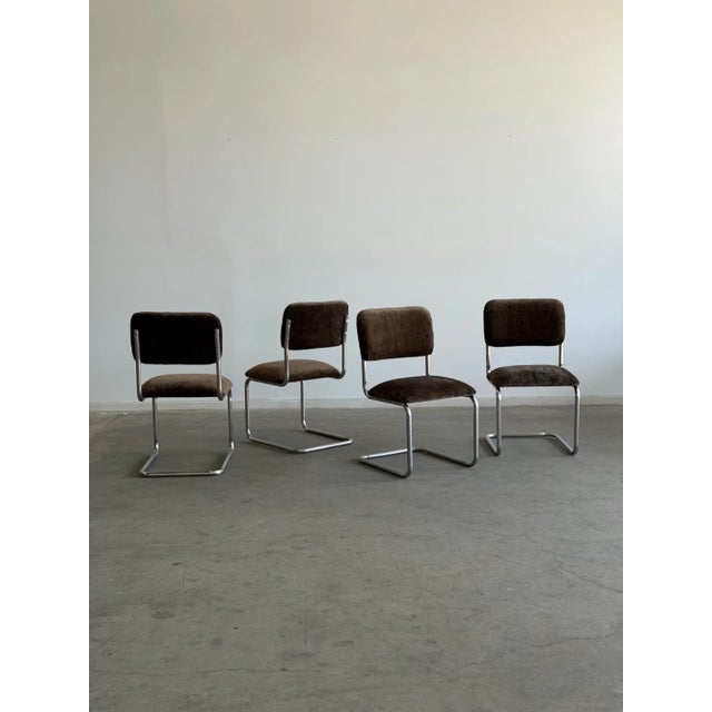 W19 D18 H34 SW18 SD15 SH19 The “Cantilever Dining Chairs in Brown Chenille” feature a signature Cantilever design,...