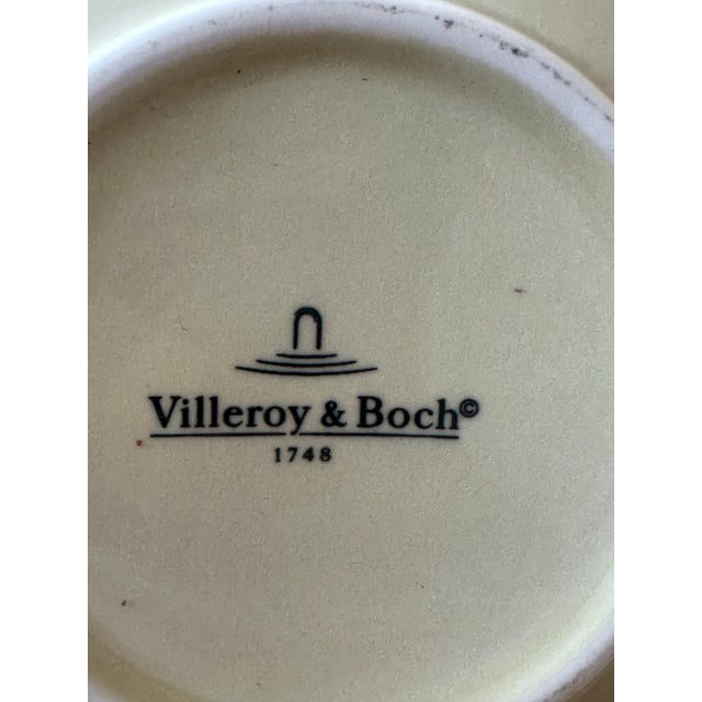 The Villeroy & Boch "THE TISANE" Teapot With an Embossed Floral Cream Color Stoneware Design and Metal Lid is a Charming...