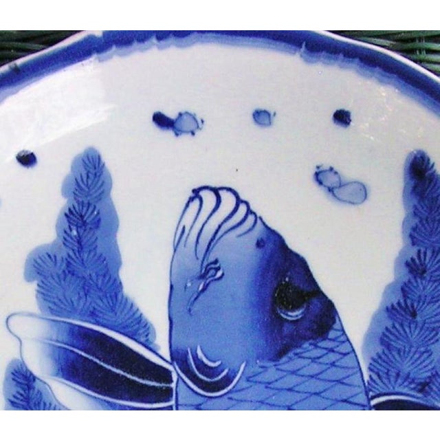 This is a bold depiction of a carp leaping from the waves, a centuries-old Japanese symbol of perseverance and grit....
