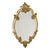 Vintage crest mirror, gold-leaf gilded, France, circa 1960s–70s. The frame is elaborately decorated with graceful, curling...