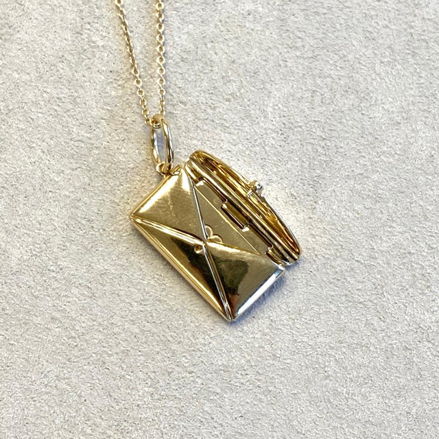 Created in 18 karat yellow gold Diamond click envelope seal Letter can be engraved if need be Heart sign on front of...