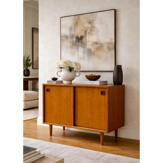 Danish Mid Century Modern Teak Jr. Credenza / Storage Cabinet, c. 1960's. This piece is highlighted by some incredible...