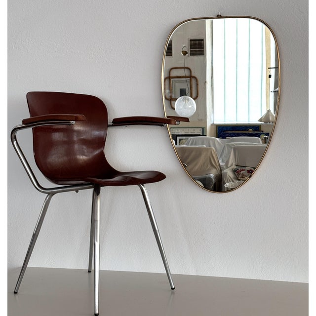 Beautiful and elegant, large vintage wall mirror with solid shiny brass frame and crystal mirror glass. Made in Italy in...