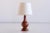 This striking table lamp was produced in Denmark in the 1960s. Sculptural organic lamp body in solid teak wood. The new...