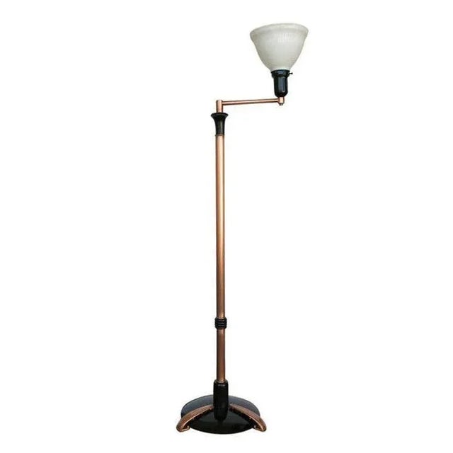Circa 1930 French Art "Streamline" Moderne copper floor lamp with black lacquer. The lamp features a unique black lacquer...