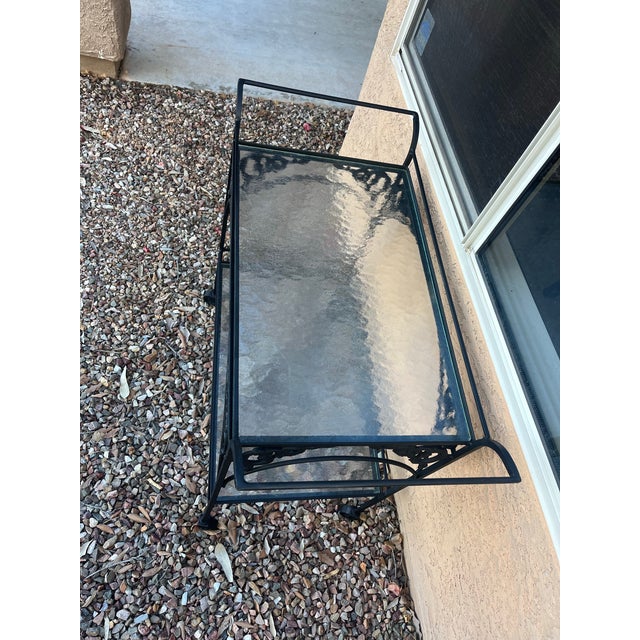 It is vintage not marked- this wrought iron bar or tea cart, Is often attributed to designers like Russell Woodard or...