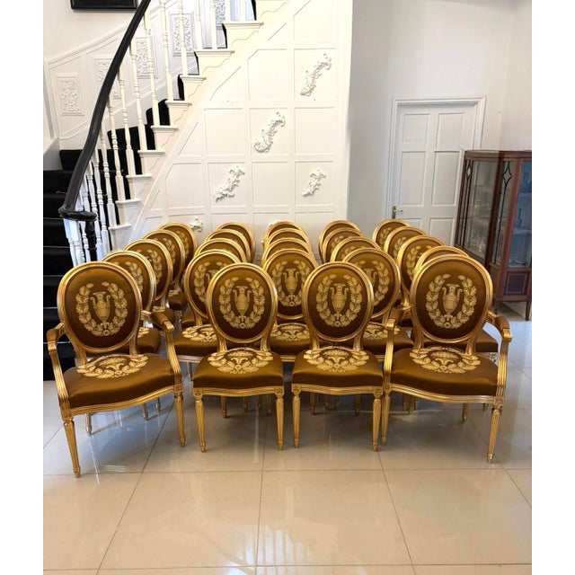 An exceptional and highly decorative suite of forty-two giltwood dining chairs comprising thirty-four single chairs and...