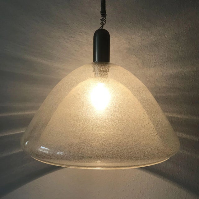 This mid-century modern pendant lamp is composed of a two-layer Peleguso glass dome, held by a polished nickel-plated stem...