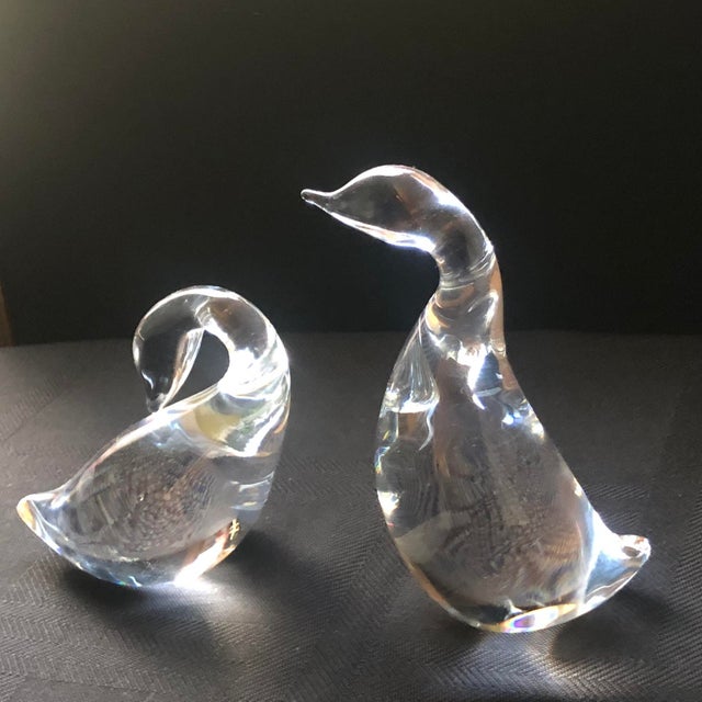 A captivating pair of authentic Mid-Century Modern solid crystal waterfowl sculptures by Steuben Glass, designed by Lloyd...