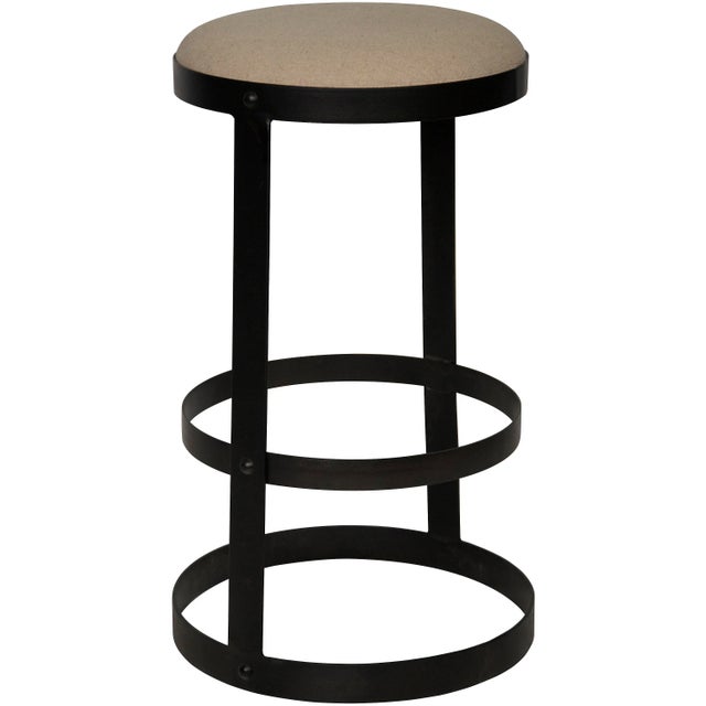 Three thick circular bands of metal form this stool's base and footrest, and support its soft linen seat. It comes in your...