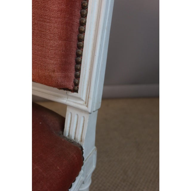 Set of eight Louis XVI style painted wooden chairs. 20th century. They are upholstered in velvet fabric, which is no...