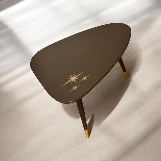 This guitar pick shaped table is modeled after the tables of the mid century era and is made from an up-cycled wood...