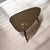 This guitar pick shaped table is modeled after the tables of the mid century era and is made from an up-cycled wood...