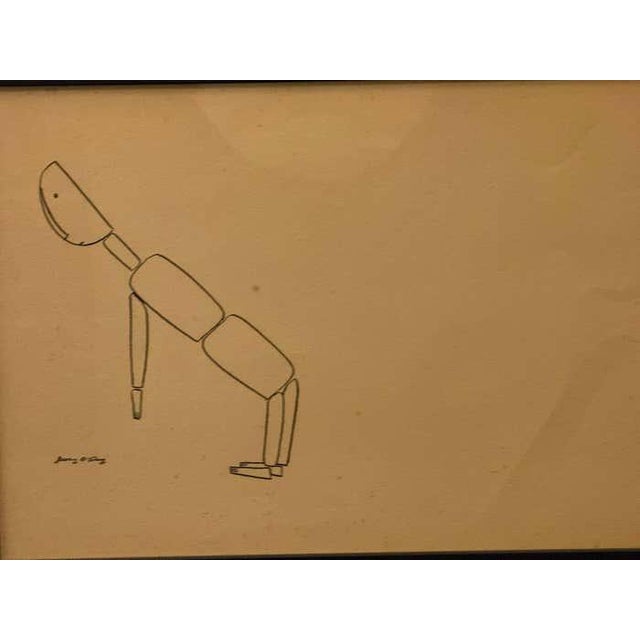 This minimalist ink drawing by Jerry O’Day presents a stylized articulated figure in mid-motion, its body reduced to a...