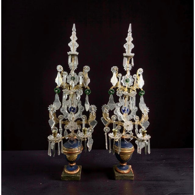 An imposing pair of neoclassical pinwheel candelabras from the louis xvi era, late 18th century. The wooden base is...