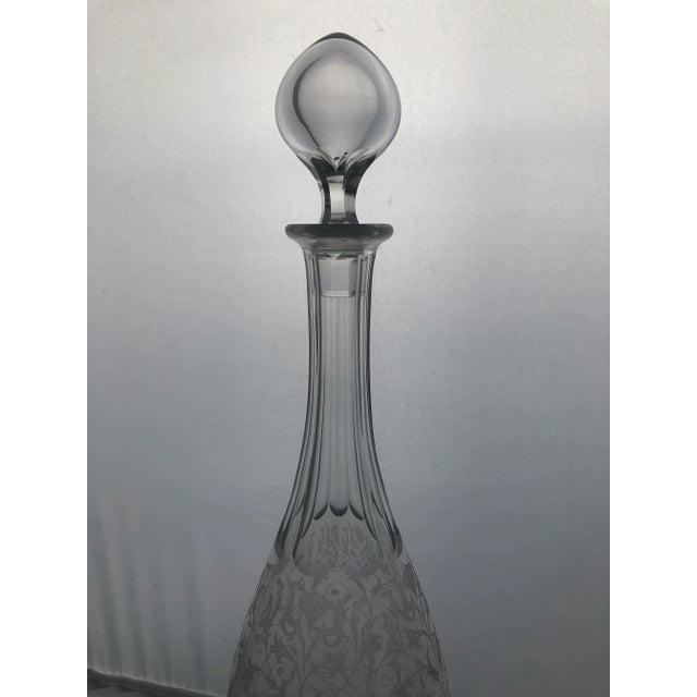 Beautiful vintage Baccarat crystal decanter with crystal stopper. This piece features an elegant floral etching and...