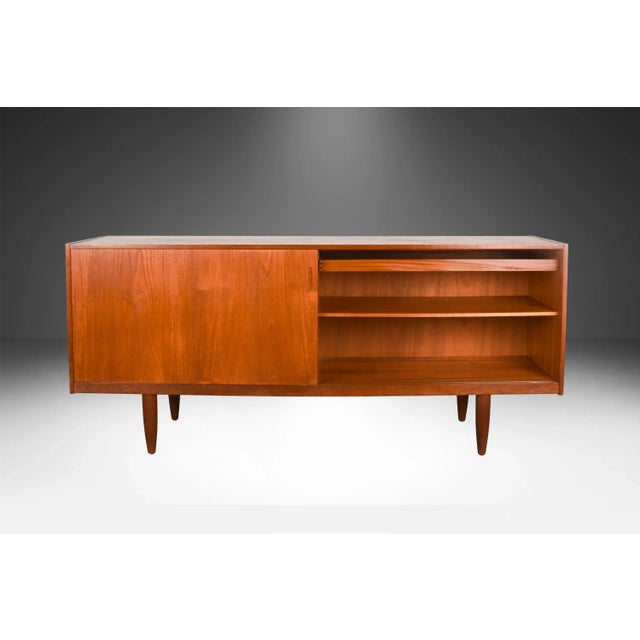 Remarkable, teak, stunning sliding door credenza made in Denmark. This Danish Modern teak credenza is beautifully...