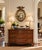 A Federal-style giltwood convex mirror crowned with a carved eagle, its wings outstretched above a laurel motif—an...