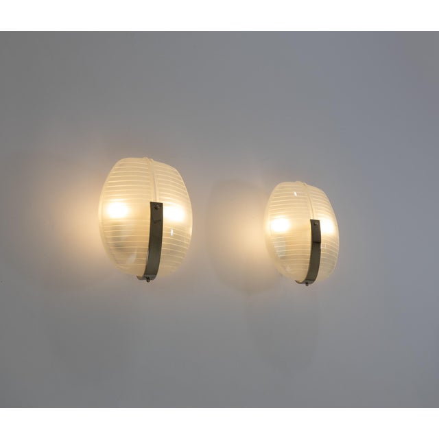 A pair of lambda wall lamps in metal and glass, designed by vico magistretti and manufactured by artemide in 1961. the...