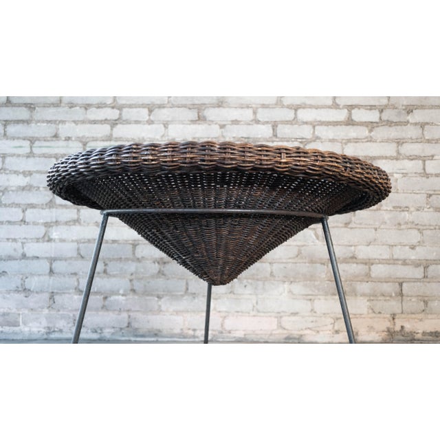 Vintage Roberto Mango attributed magazine rack, circa 1960s. Woven rattan basket that sits inside painted metal rod base....