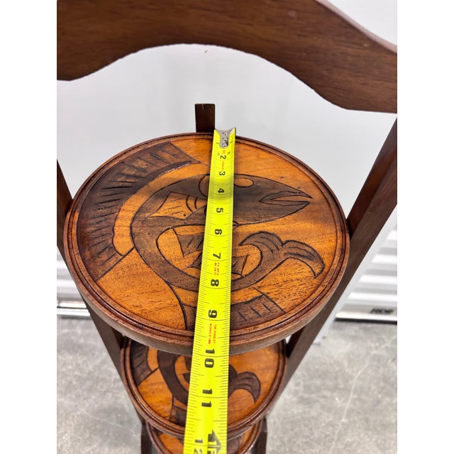 Vintage folding plant stand Dark finished wood frame with three rounded shelves Charming koi fish design carved along each...