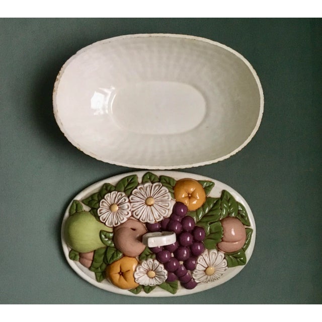An amazing faux fruit garden basketweave ceramic dish in very good overall condition with a colorful variety of flowers...