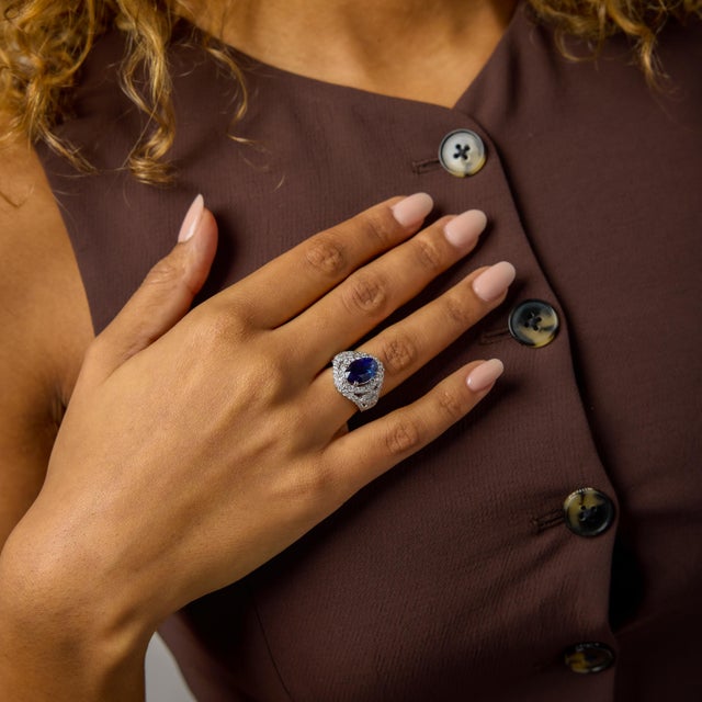 This vintage cocktail ring is a dramatic and beautifully composed statement of color and brilliance. At its center rests...