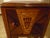This is a 19th century bed stand. Rich in color tones. Inlaid color flowers in wood . Original door pull in burgundy. One...
