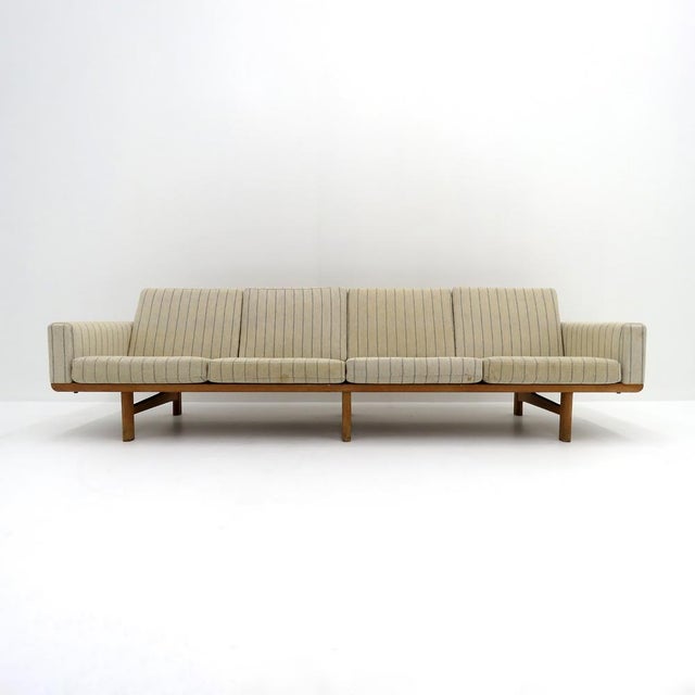 wonderful Danish four-seater sofa, model GE236/4 designed by Hans J. Wegner for GETAMA, 1950, with a solid oak frame and...