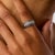 This elegant vintage band showcases a beautifully balanced design of 7 round brilliant cut diamonds totaling approximately...