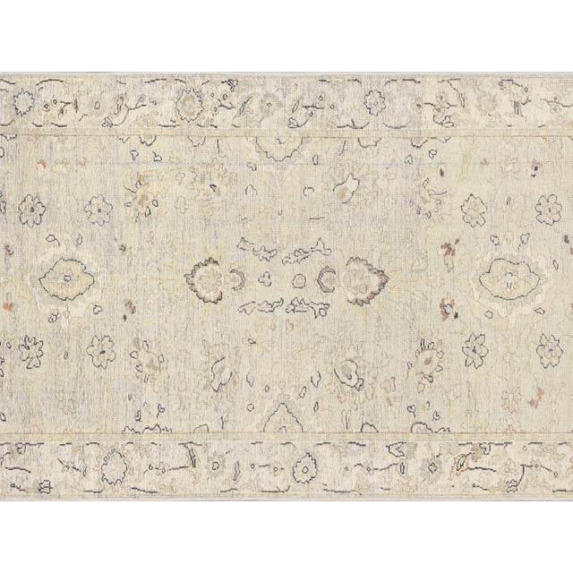 This vintage Persian Tabriz runner, measuring 2'8" x 13'3", is handwoven with wool on a cotton foundation in Iran's Tabriz...