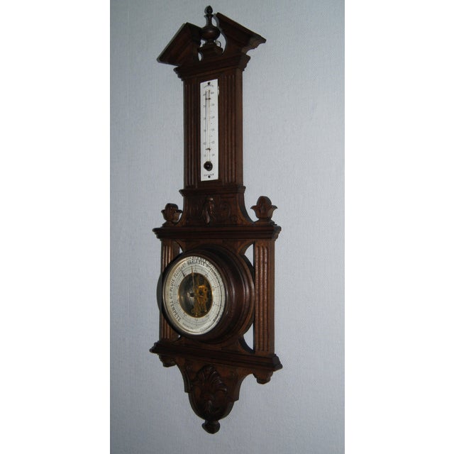 A beautiful open dial antique weather station, barometer, thermometer with beveled edges, carved wooden details. Old...