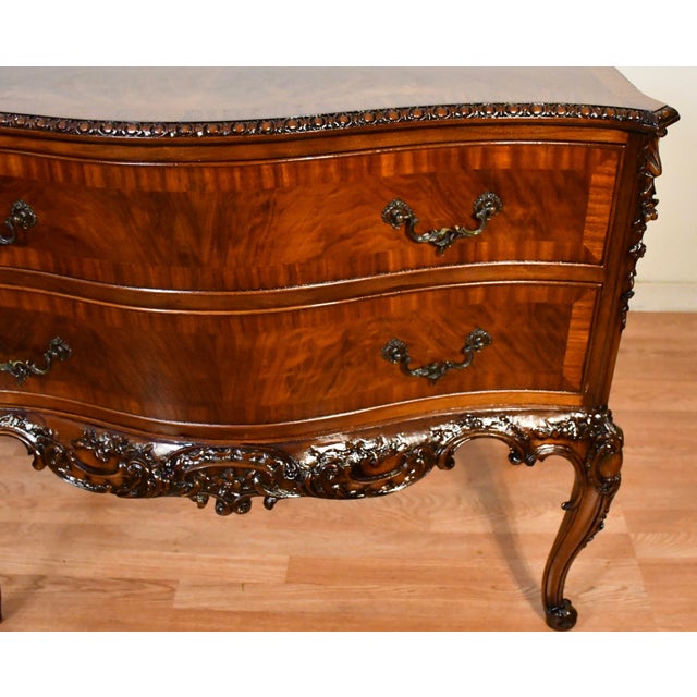 A beautifully crafted antique lowboy in the elegant Louis XV Style, showcasing exceptional burl walnut veneers with...