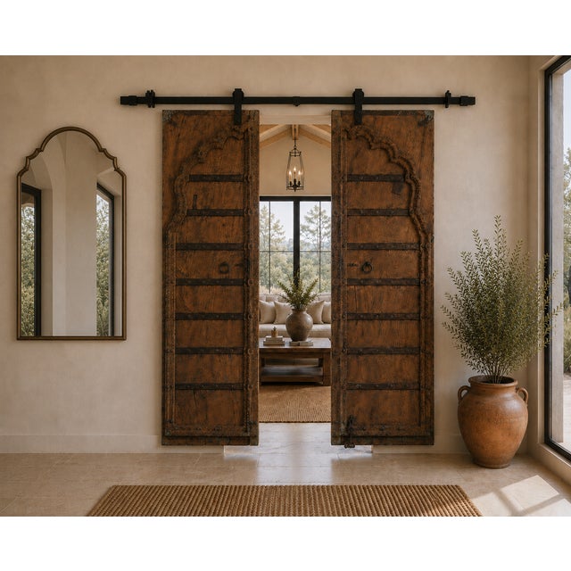 Antique Indian Carved Teakwood and Iron Door, the top with a shaped arch, with a carved outline and center style. A very...