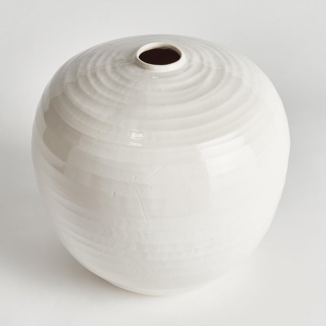 A classic rotund shape and a very narrow opening makes this vase perfect for a single branch or tall faux floral stem. The...