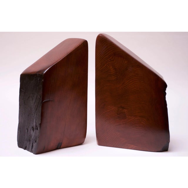 Striking sculptural douglas fir live edge bookends (circa 1970s USA). Solid 'blocks' of stained douglas fir have been...