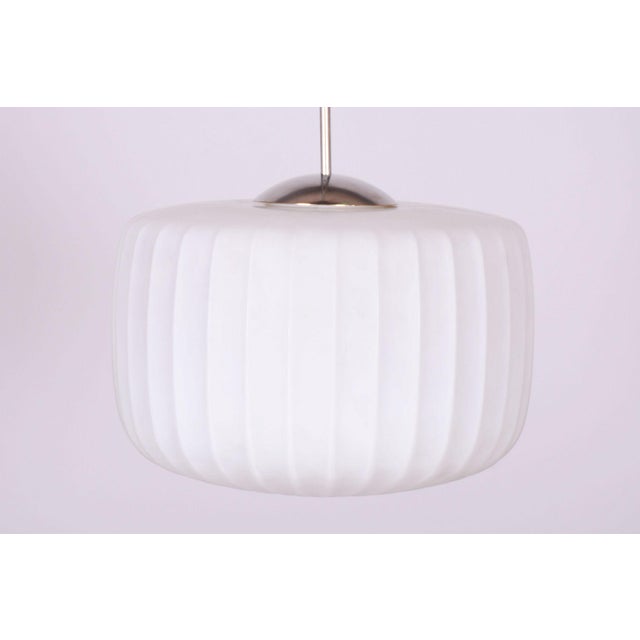 This stylish and visually captivating pendant chandelier, originating from the 1950s, represents an exceptionally...