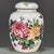 A charming Chinese porcelain covered jar. The white ground is beautifully hand-painted in vibrant Famille Rose enamels,...