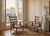 This is a pair of elegant armchairs designed by Paolo Buffa, crafted from solid cherry wood with a warm reddish-brown hue....