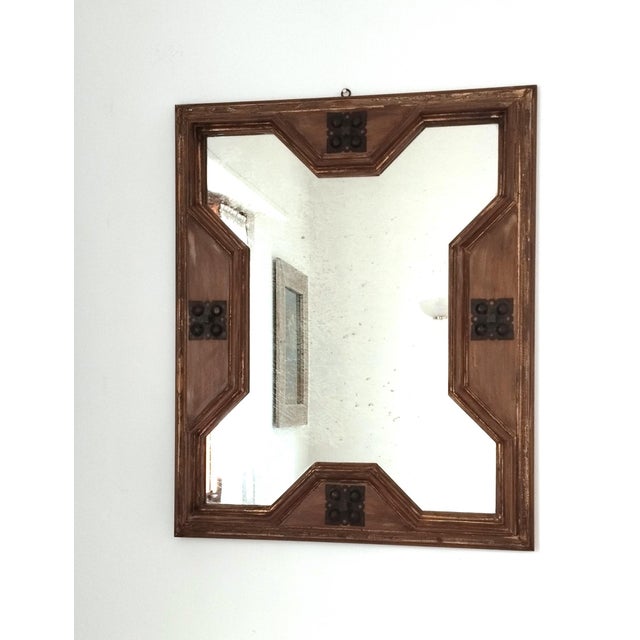 Italian mirror in Rustic Mediterranean Revival style, featuring a handcrafted wooden frame with decorative wrought iron...