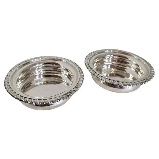 A fine pair of antique sterling silver coasters dating to 1901, displaying an elegant and restrained Edwardian design....