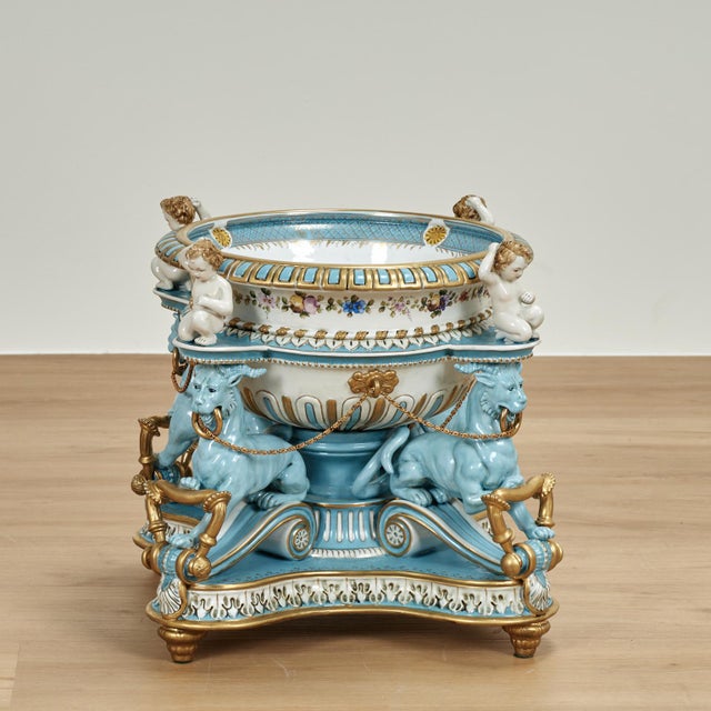 Lofty 19th century French porcelain centerpiece decorated in blue, white and gold, having an extravagant composition with...