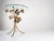 This accent side table reflects the Hollywood Regency and Mid-Century Modern aesthetic of the 1970s, characterized by its...