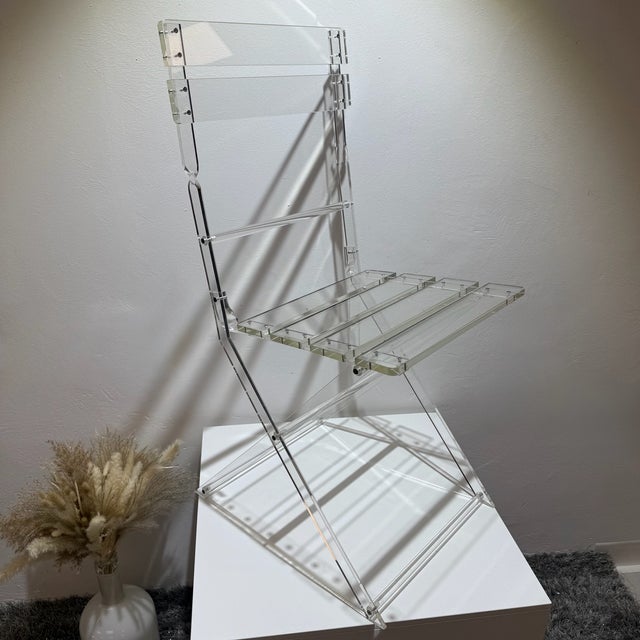 This extraordinary chair is a visual highlight of Space Age design. Crafted from solid, clear acrylic glass, it...