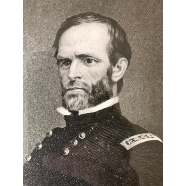 A framed presentation piece featuring a portrait of Civil War General William Tecumseh Sherman, accompanied by a mounted...
