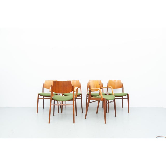 Six dining chairs by Wilkhahn: four C64 models and two D64 models with armrests, crafted from teak with newly...