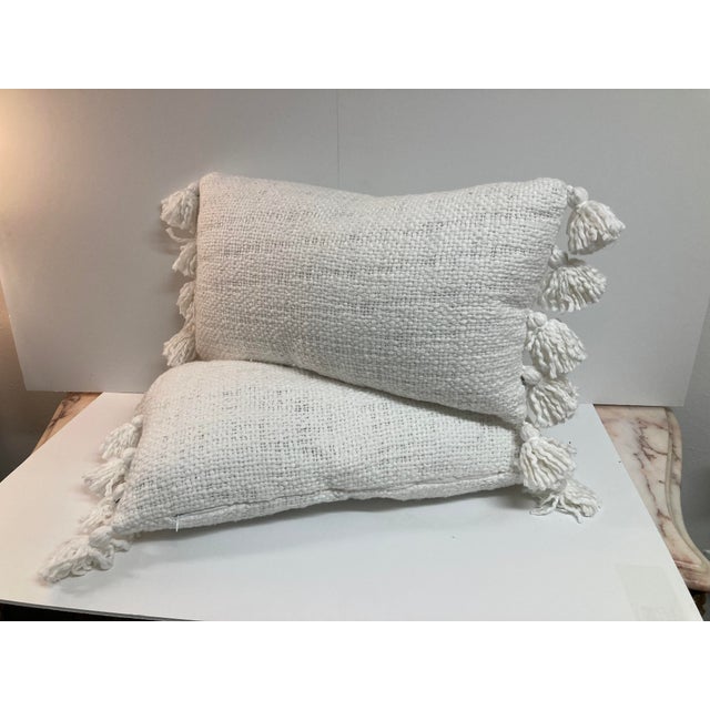 Amazing pair of natural raw silk decorative toss pillows with tassels in the style of Jean Michel Frank. This fabric was a...
